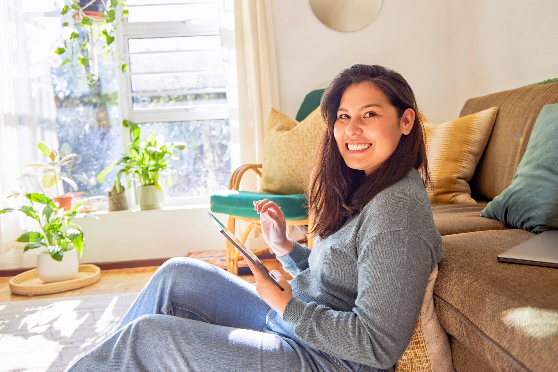Girl sitting in living room on tablet